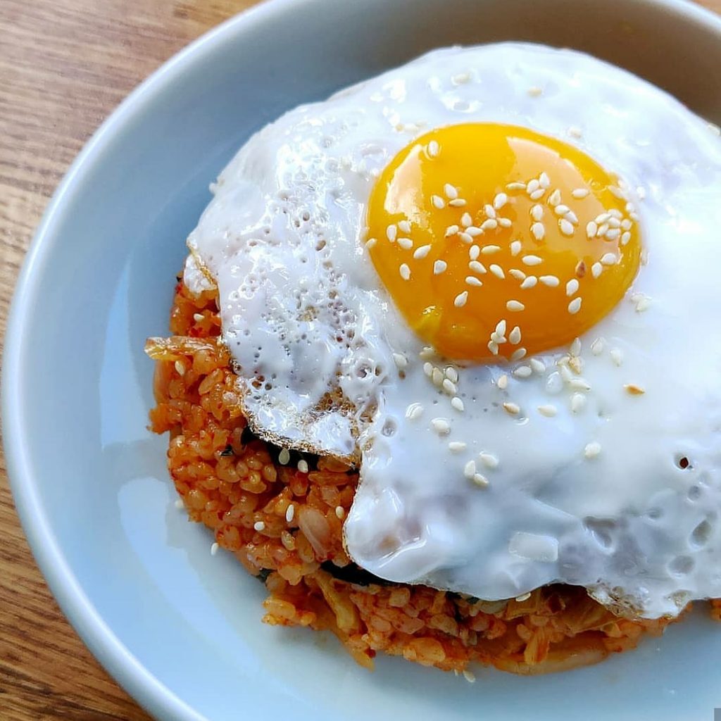 A photo of kimchi fried rice with a fried egg.